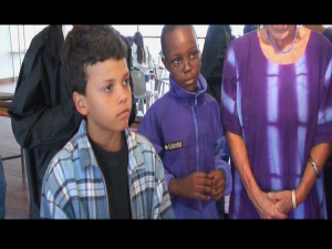 Children participants in Lola Kenya Screen's film production workshop stand back to watch their animation work